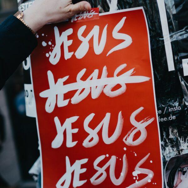 person holding red and white coca cola poster